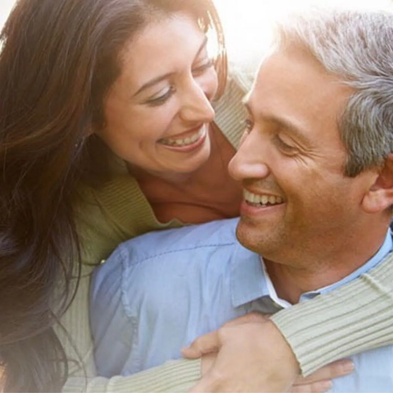 A couple in their fifties, close and laughing