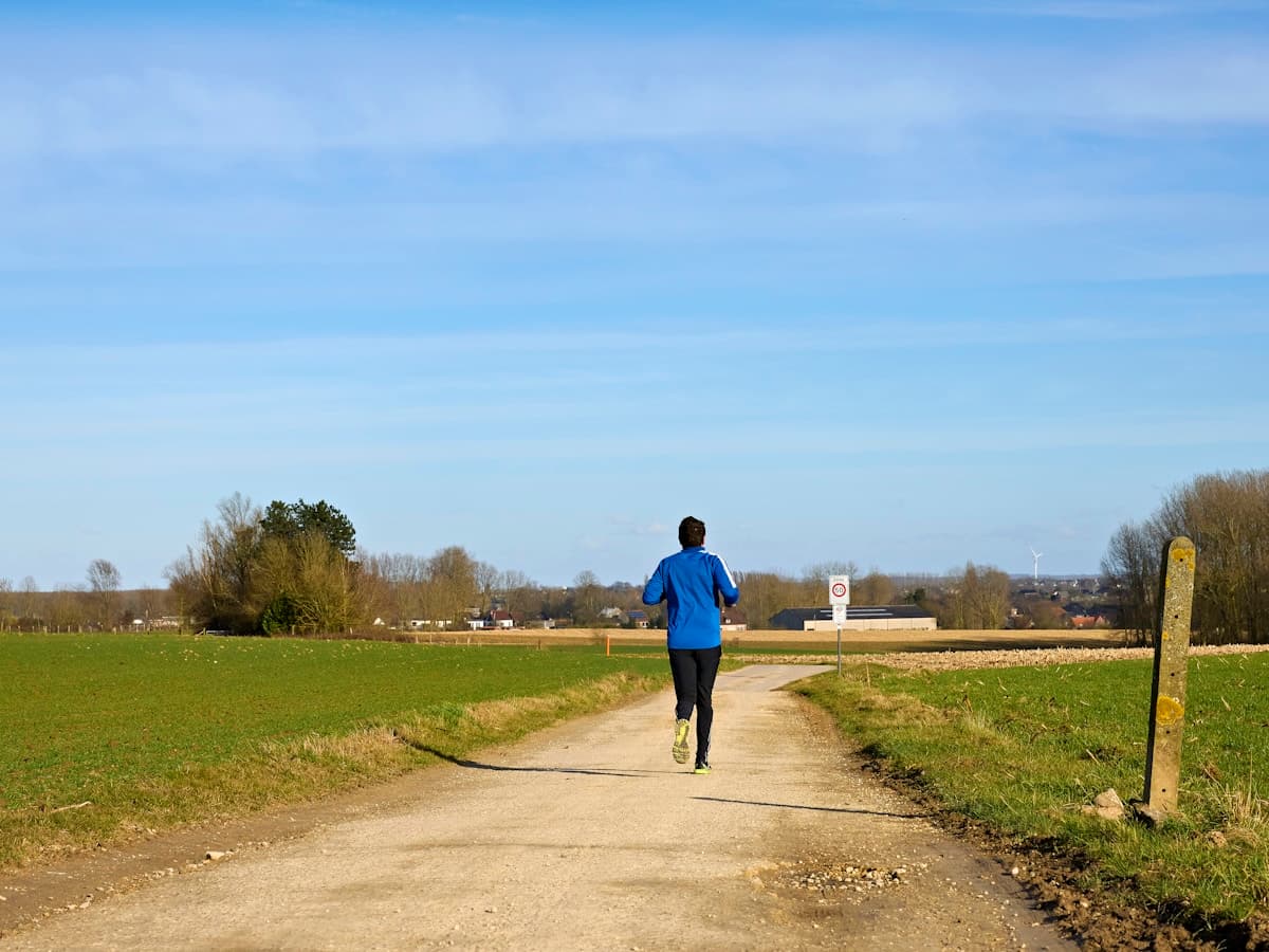 Fit man running outdoors on trail