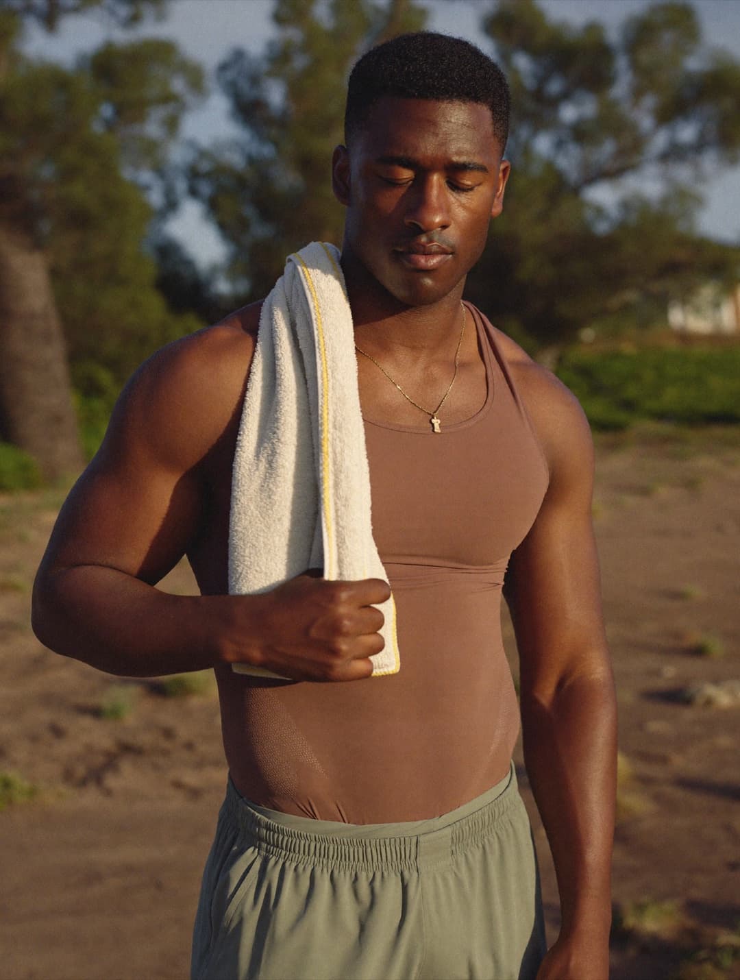 Athletic man recovering outdoors after exercise